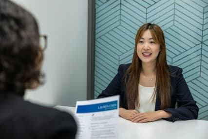 Professional woman at desk for cover letter tips